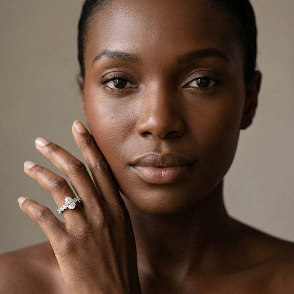 White gold Pear Brilliant Solitaire with Side Stones on a Pave Band and Four-Prong Setting