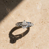 White gold Pear Brilliant Solitaire with Side Stones on a Pave Band and Four-Prong Setting_17