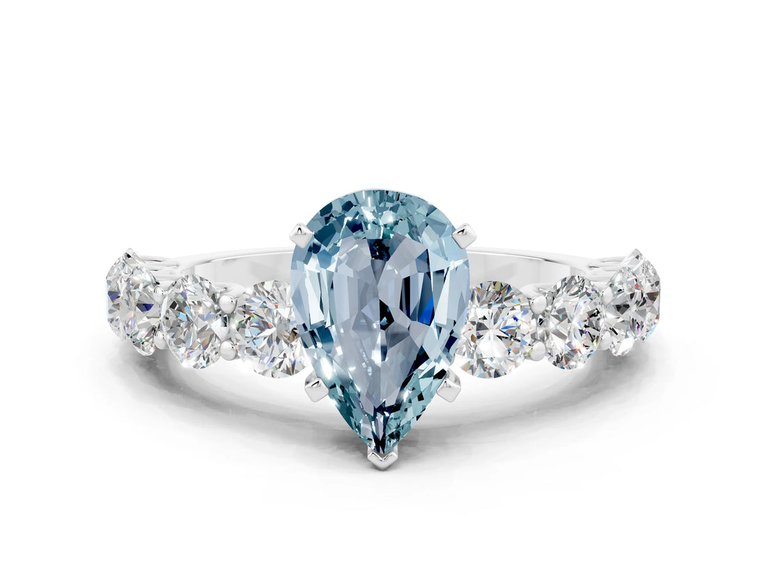 White gold Pear Cut Aquamarine Prong Setting with Side Stones on a Pave Band