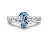 White gold Pear Cut Aquamarine Prong Setting with Side Stones on a Pave Band
