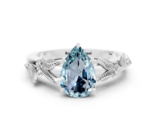 Platinum Pear Cut Aquamarine Solitaire Ring with Leaf Motif Band and Four-Prong Setting