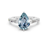 White gold Pear Cut Aquamarine Solitaire with Side Baguettes and Channel Set Band