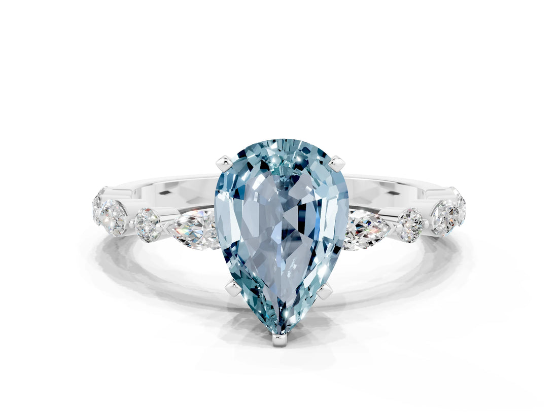 White gold Pear Cut Aquamarine Solitaire with Side Stones on a Pavé Band and Four-Prong Setting