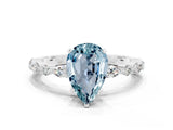 White gold Pear Cut Aquamarine Solitaire with Side Stones on a Pavé Band and Four-Prong Setting