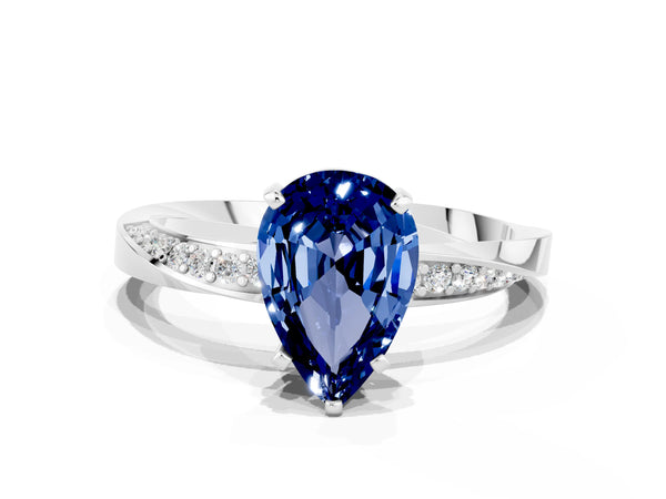 White gold Pear Cut Blue Sapphire Engagement Ring with Side Stone Accents and Four-Prong Setting