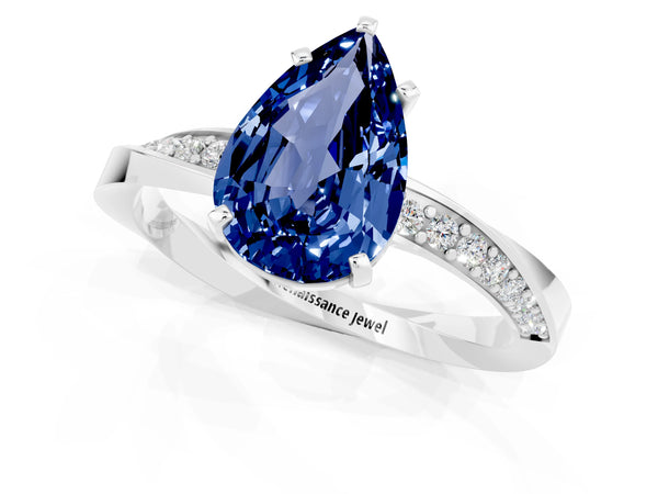 White gold Pear Cut Blue Sapphire Engagement Ring with Side Stone Accents and Four-Prong Setting
