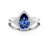 White gold Pear Cut Blue Sapphire Halo Ring with Tapered Band and Four-Prong Setting