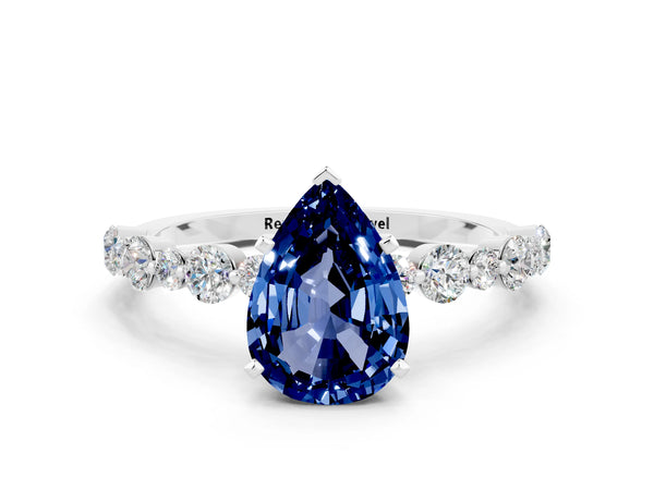 Platinum Pear Cut Blue Sapphire Prong Set Engagement Ring with Pavé Band