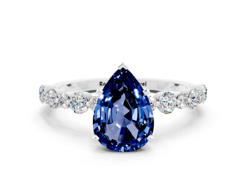 White gold Pear Cut Blue Sapphire Prong Set Engagement Ring with Pavé Band