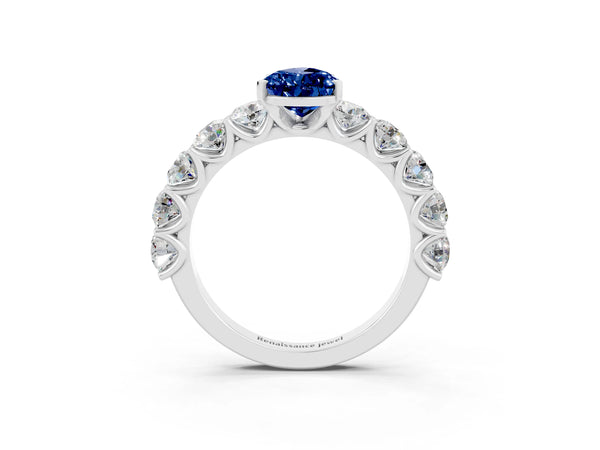 Platinum Pear Cut Blue Sapphire Prong Setting with Side Stones on a Pave Band