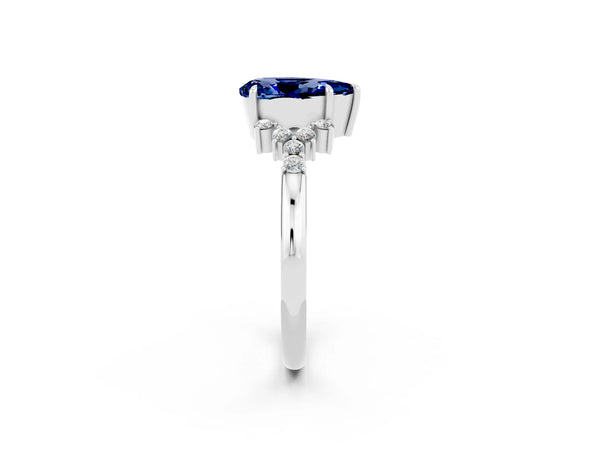 Silver Pear Cut Blue Sapphire Ring with Side Stones and Four-Prong Setting