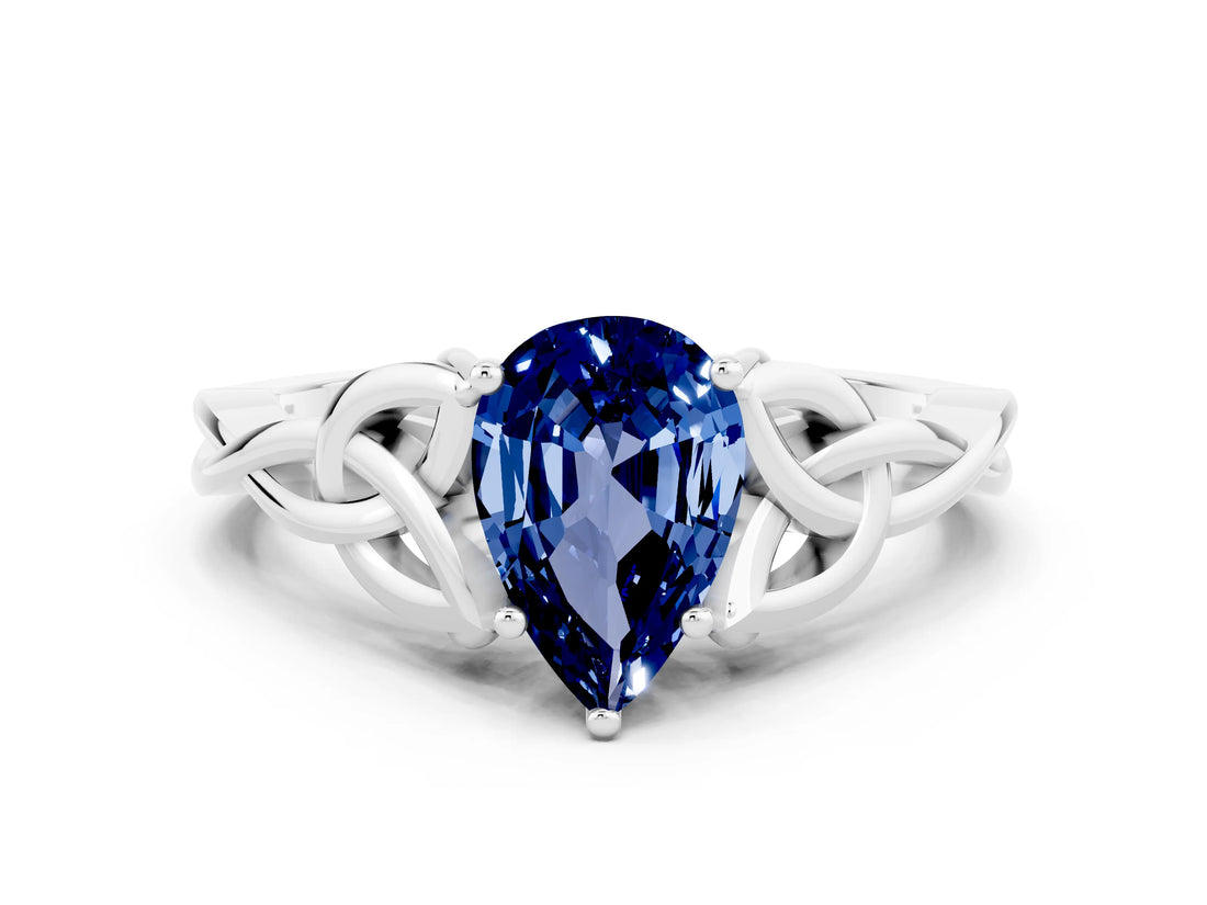 White gold Pear Cut Blue Sapphire Solitaire Engagement Ring with Celtic Knot Band and Four-Prong Setting