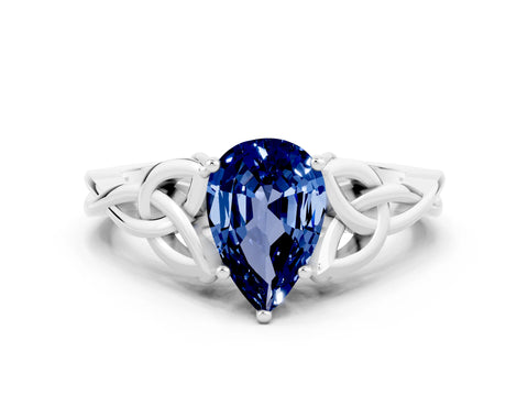 White gold Pear Cut Blue Sapphire Solitaire Engagement Ring with Celtic Knot Band and Four-Prong Setting