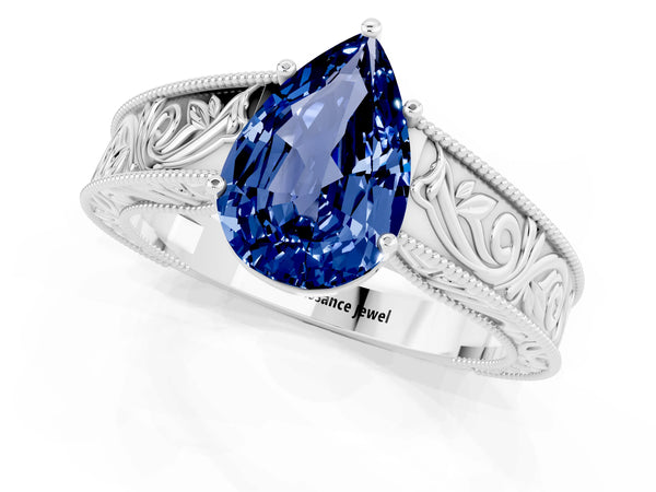 Platinum Pear Cut Blue Sapphire Solitaire Ring with Engraved Band and Four-Prong Setting
