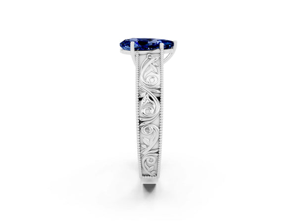 Platinum Pear Cut Blue Sapphire Solitaire Ring with Engraved Band and Four-Prong Setting