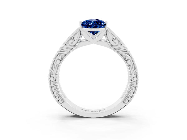 Silver Pear Cut Blue Sapphire Solitaire Ring with Engraved Band and Four-Prong Setting
