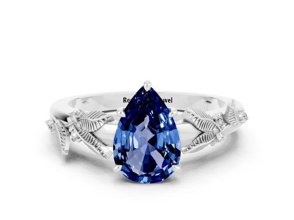 White gold Pear Cut Blue Sapphire Solitaire Ring with Leaf Motif Band and Four-Prong Setting