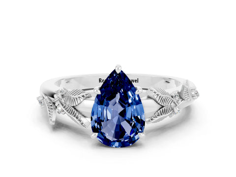 White gold Pear Cut Blue Sapphire Solitaire Ring with Leaf Motif Band and Four-Prong Setting