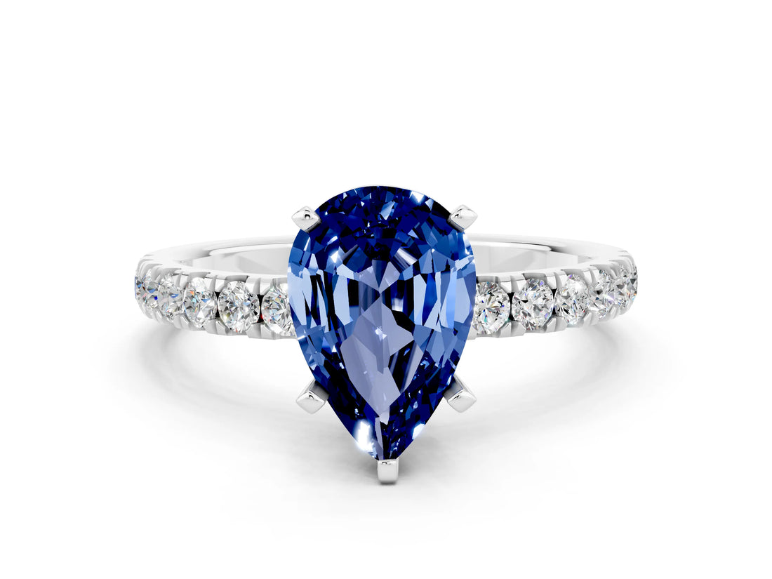 White gold Pear Cut Blue Sapphire Solitaire Ring with Pavé Accents and Four-Prong Setting
