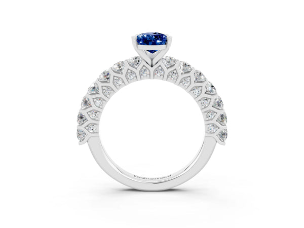 White gold Pear Cut Blue Sapphire Solitaire Ring with Shared Prong Pavé Band and Four-Prong Setting