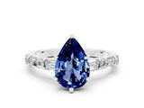 White gold Pear Cut Blue Sapphire Solitaire with Side Baguettes and Channel Set Band