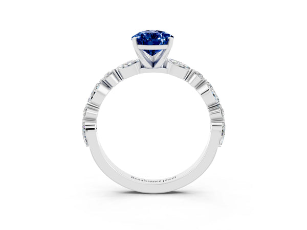 Platinum Pear Cut Blue Sapphire Ring with Marquise and Round  Side Stones and Four-Prong Setting