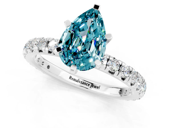 Platinum Pear Cut Blue Topaz Pavé Solitaire Ring with Round Band and Prong Setting