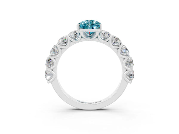 Platinum Pear Cut Blue Topaz Prong Setting with Side Stones on a Pave Band