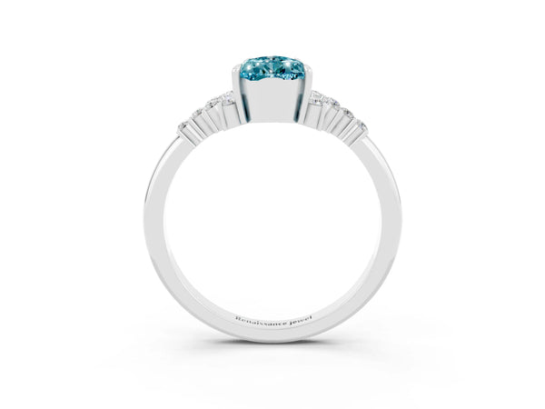 Platinum Pear Cut Blue Topaz Ring with Side Stones and Four-Prong Setting
