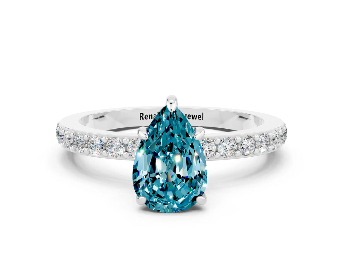 White gold Pear Cut Blue Topaz Solitaire Engagement Ring with Pavé Band and Four-Prong Setting