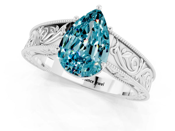 Silver Pear Cut Blue Topaz Solitaire Ring with Engraved Band and Four-Prong Setting