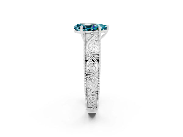 Silver Pear Cut Blue Topaz Solitaire Ring with Engraved Band and Four-Prong Setting