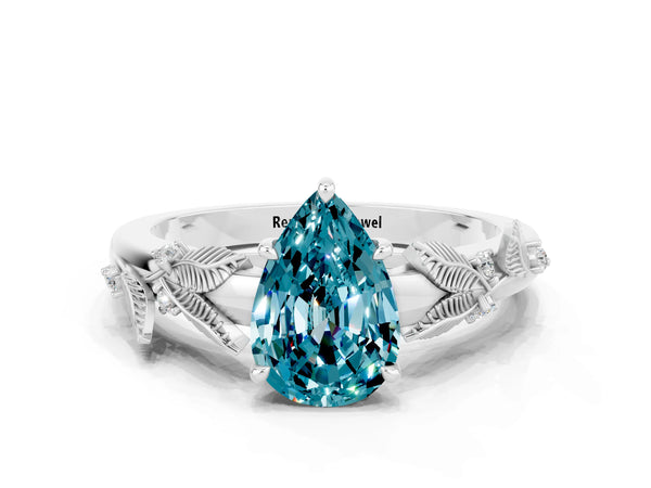 Silver Pear Cut Blue Topaz Solitaire Ring with Leaf Motif Band and Four-Prong Setting