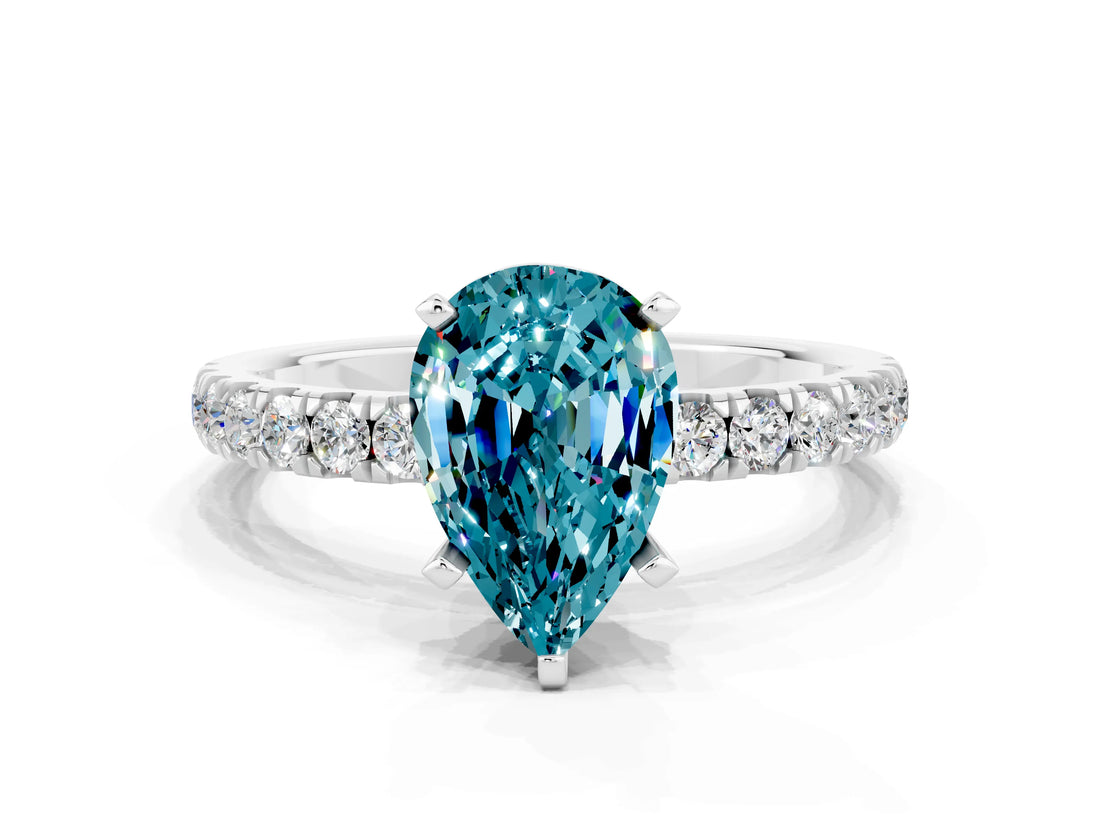 White gold Pear Cut Blue Topaz Solitaire Ring with Pavé Accents and Four-Prong Setting