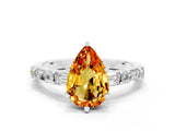 White gold Pear Cut Citrine Solitaire with Side Baguettes and Channel Set Band