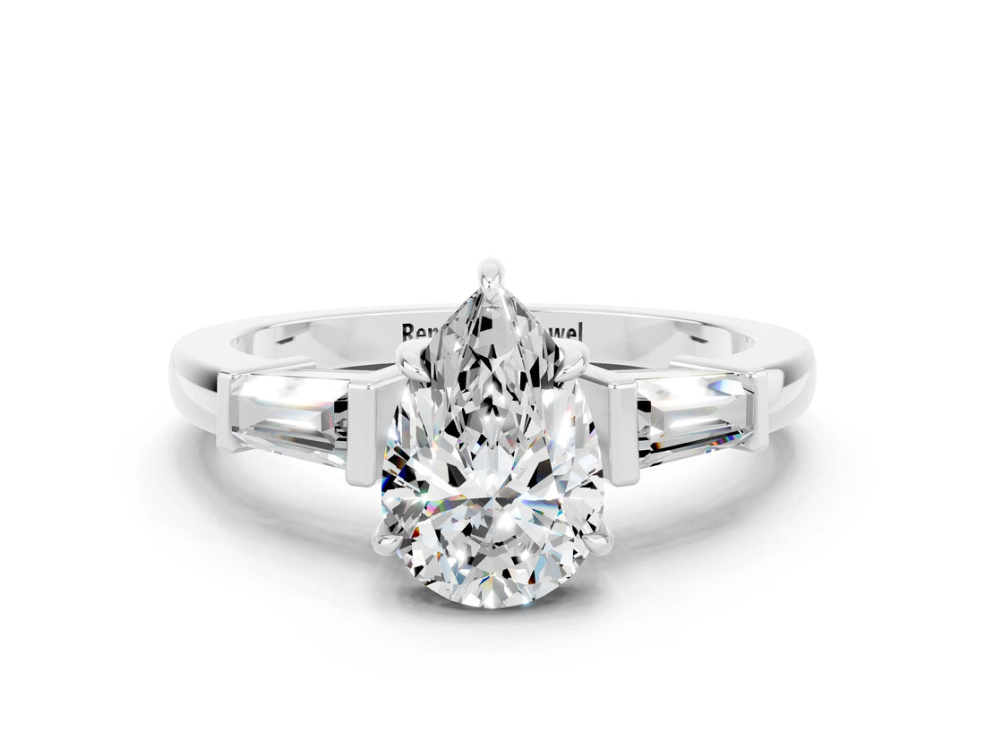White gold Pear Cut Cut Diamond Ring with Tapered Baguette Side Stones in Four-Prong Setting