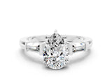 White gold Pear Cut Cut Diamond Ring with Tapered Baguette Side Stones in Four-Prong Setting