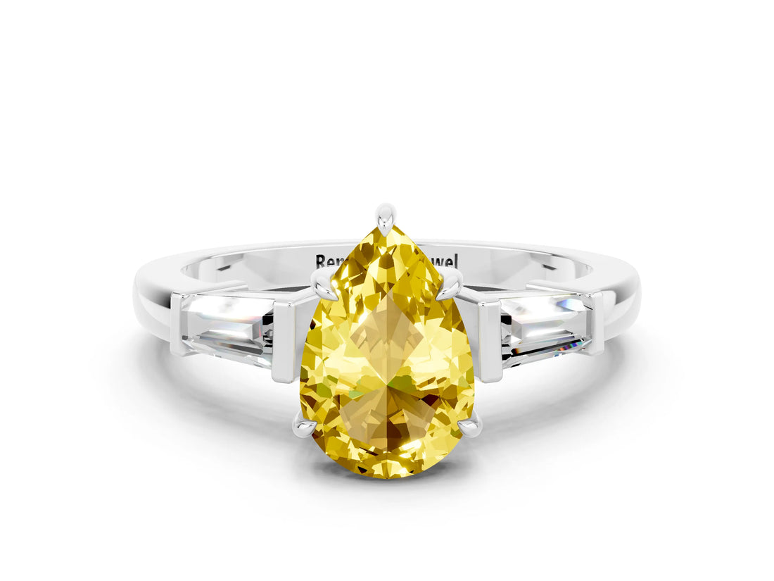 White gold Pear Cut Cut Diamond Ring with Tapered Baguette Side Stones in Four-Prong Setting