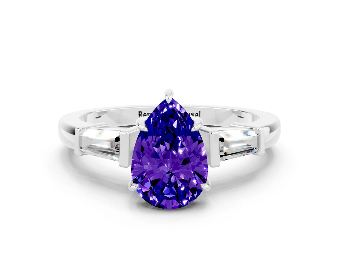 White gold Pear Cut Cut Diamond Ring with Tapered Baguette Side Stones in Four-Prong Setting