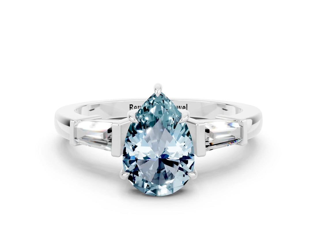 White gold Pear Cut Cut Diamond Ring with Tapered Baguette Side Stones in Four-Prong Setting