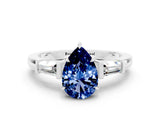 White gold Pear Cut Cut Diamond Ring with Tapered Baguette Side Stones in Four-Prong Setting