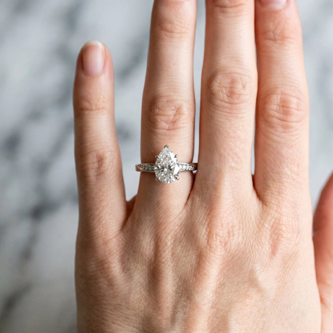 White gold Pear Cut Diamond Engagement Ring with Side Stone Accents and Four-Prong Setting_51