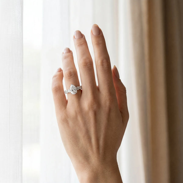 White gold Pear Cut Diamond Prong Setting with Side Stones on a Pave Band
