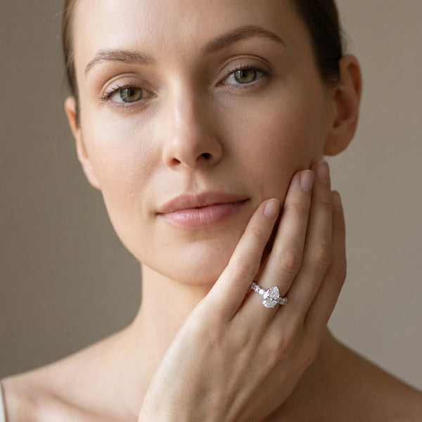 White gold Pear Cut Diamond Prong Setting with Side Stones on a Pave Band