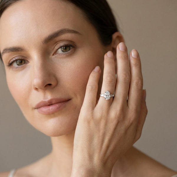 White gold Pear Cut Diamond Ring with Baguette Side Stones, Channel Set Band, and Four-Prong Setting