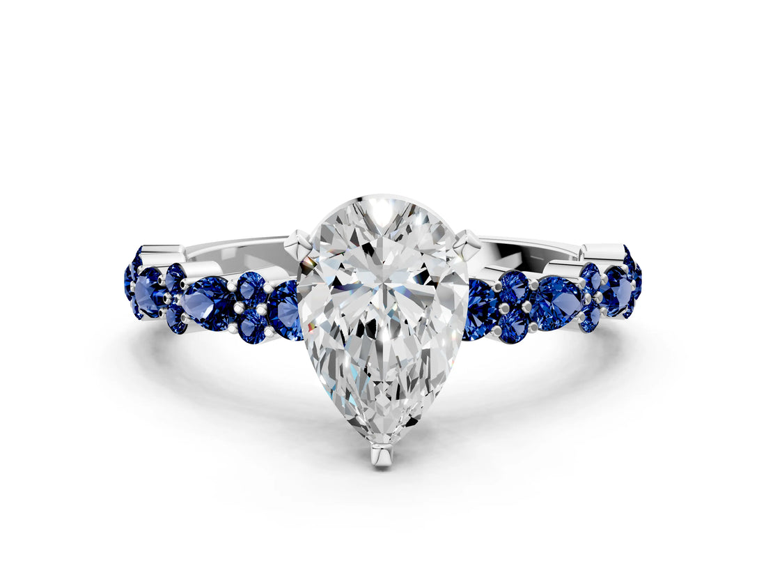 White gold Pear Cut Diamond Side Stone Solitaire Ring with Round with Blue Sapphire side stone and Four-Prong Setting
