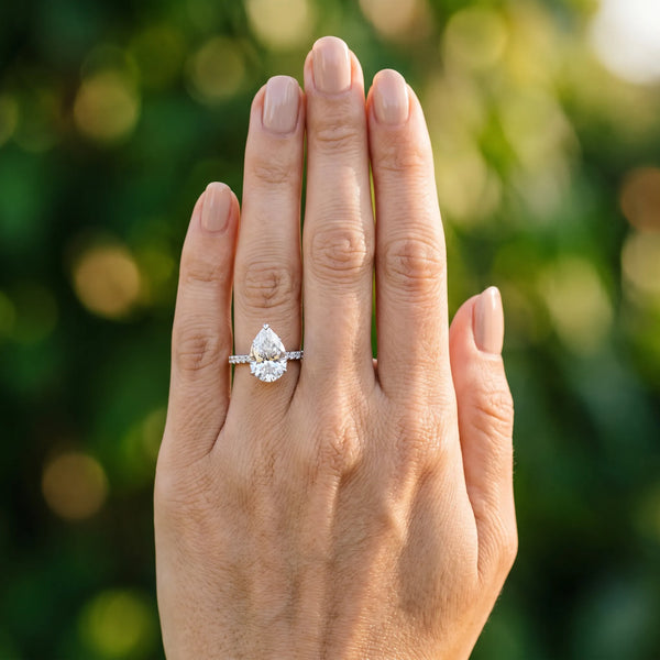White gold Pear Cut Diamond Solitaire Engagement Ring with Round  Pavé Band and Prong Setting
