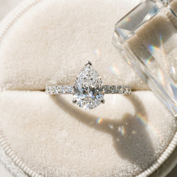 White gold Pear Cut Diamond Solitaire Engagement Ring with Round  Pavé Band and Prong Setting