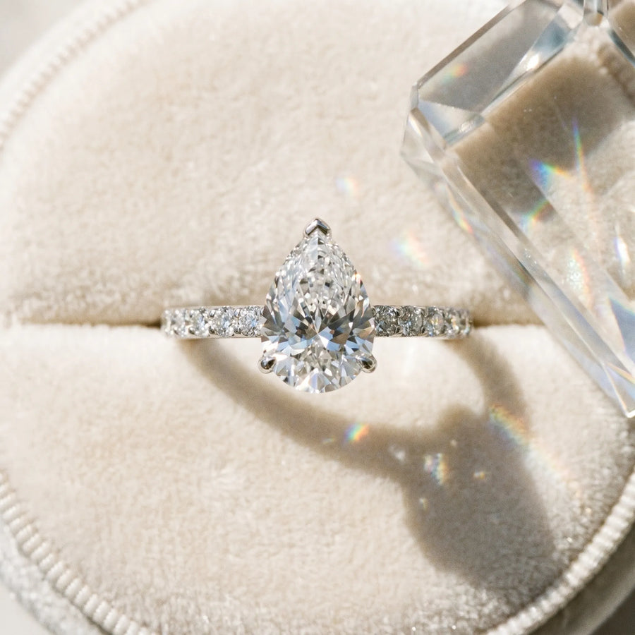 White gold Pear Cut Diamond Solitaire Engagement Ring with Round  Pavé Band and Prong Setting