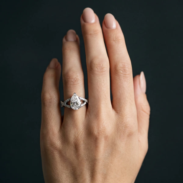 White gold Pear Cut Diamond Solitaire Ring with Four-Prong Setting and Twisted Pavé Band